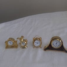 We are selling 4 miniature clocks