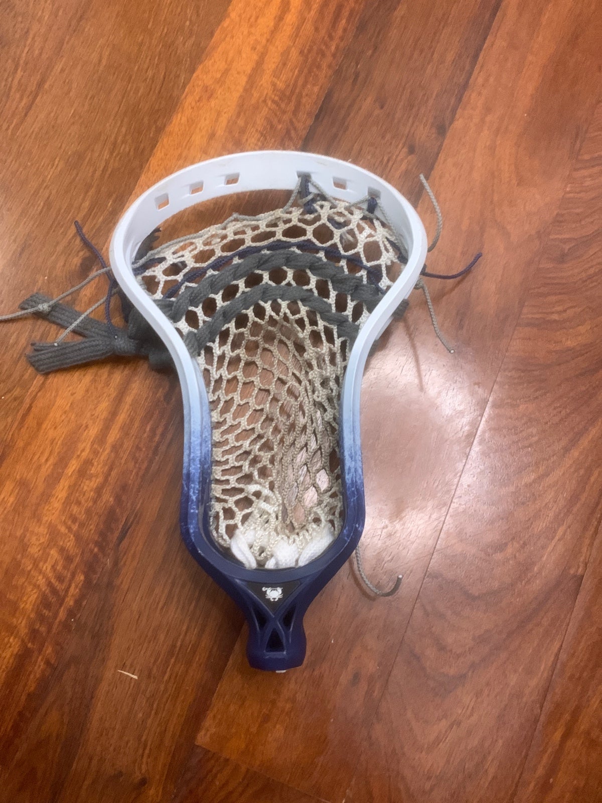 A white and blue detailed, rebel ECD lacrosse head