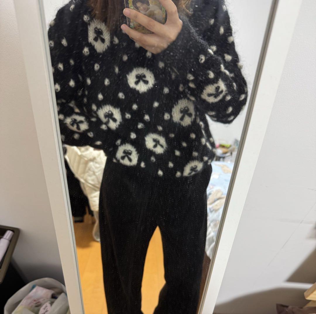 Long-sleeved knit sweater in black with ribbon dot design.