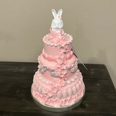 Pink Easter cake with white bunny floral 3 tier fake food flowers