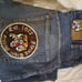 Vintage Men's Baggy Blue Jeans by Evolution in Design with an Embroidered Patch