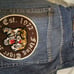 Vintage Men's Baggy Blue Jeans by Evolution in Design with an Embroidered Patch