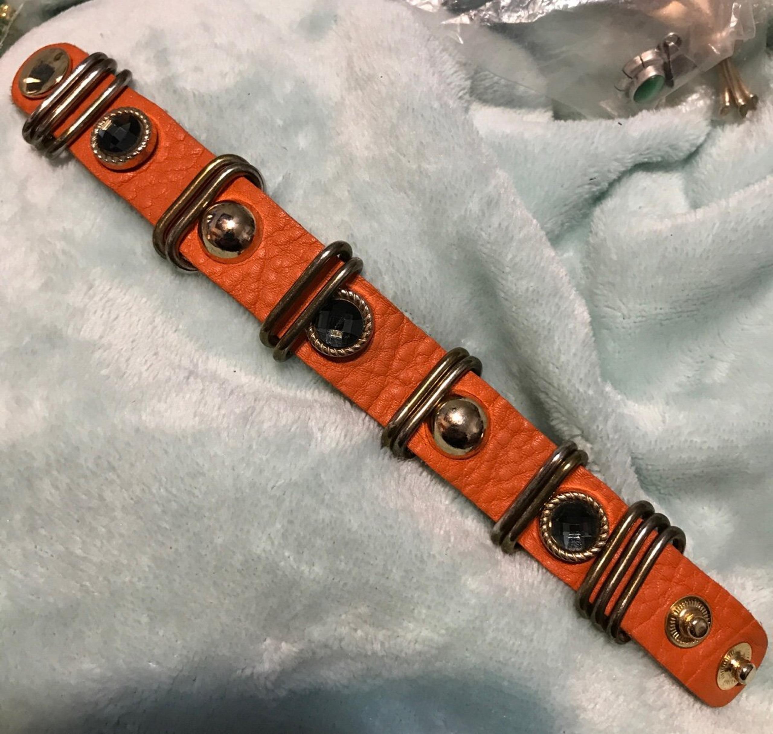 Orange soft leather bracelet with blue stones and gold buttons