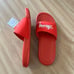 Benassi x Stüssy habanero red slides