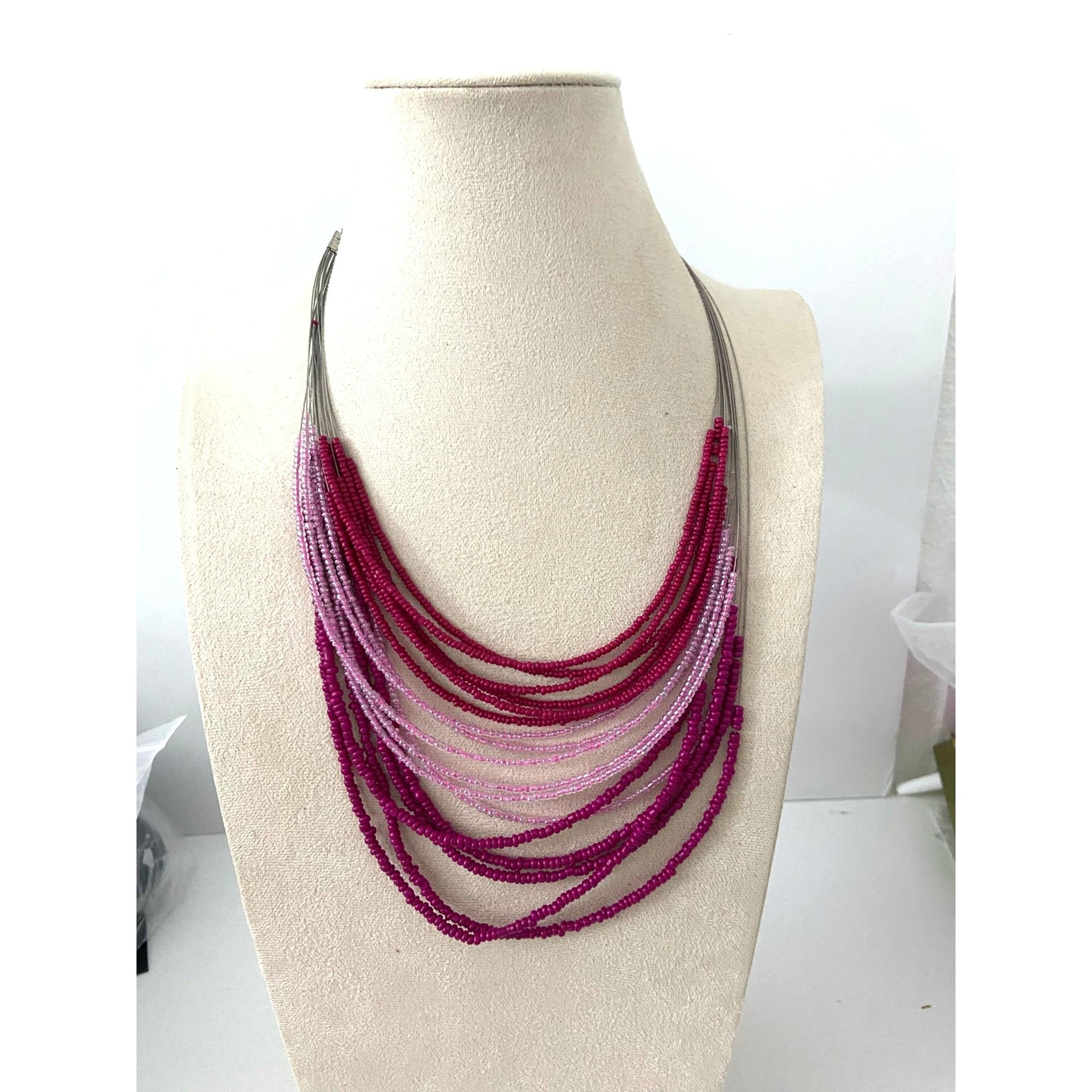 layered bright pink bead necklace