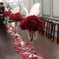 10 gold trumpet vases w/ red hydrangeas, pearls and ivory ostrich feathers