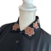 ♦︎Unused Faller Polo Shirt, Black with a subdued brown floral pattern.