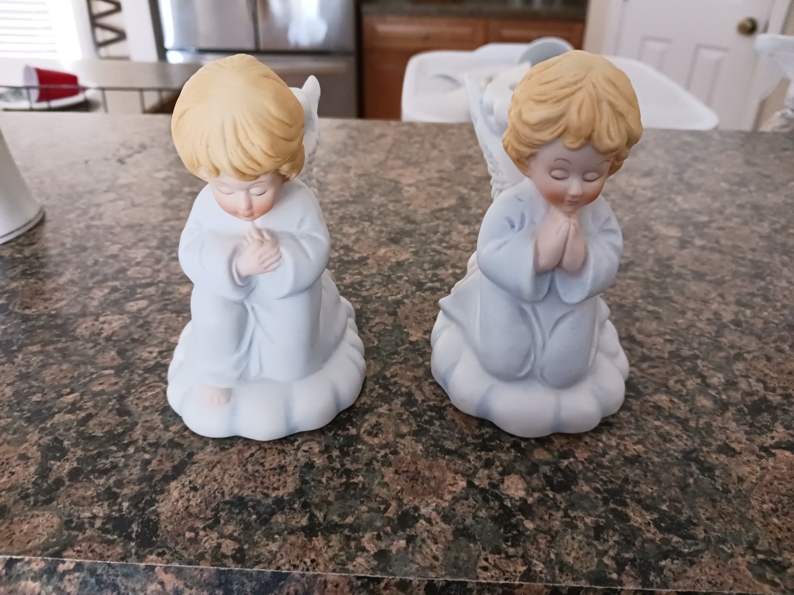 Angel candle holders praying hosts