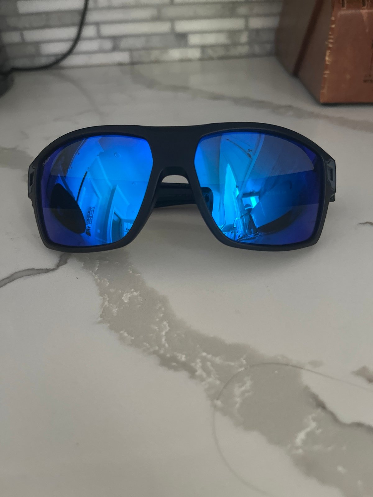 Costa black sunglasses with blue tinted lenses