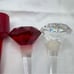 Towle Crystal Wine Stoppers and 2 signed Oleg Cassini one red unsigned lot of 5