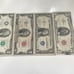 4 bills one dollar bill and two dollar bill and one five dollar bill