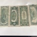 4 bills one dollar bill and two dollar bill and one five dollar bill