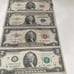 4 bills one dollar bill and two dollar bill and one five dollar bill