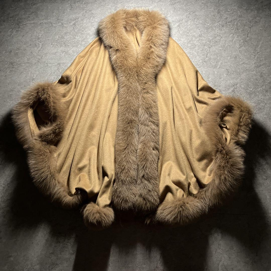 Like new Saga Furs poncho made of cashmere with blue fox fur.