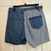 Large Bailey Rise “Check Me Out” med/light wash denim raw hem Bermuda shorts.