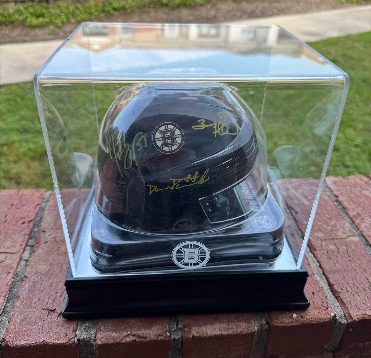 Boston Bruins “The Perfection Line” Authentic Signed Mini Helmet & Pucks