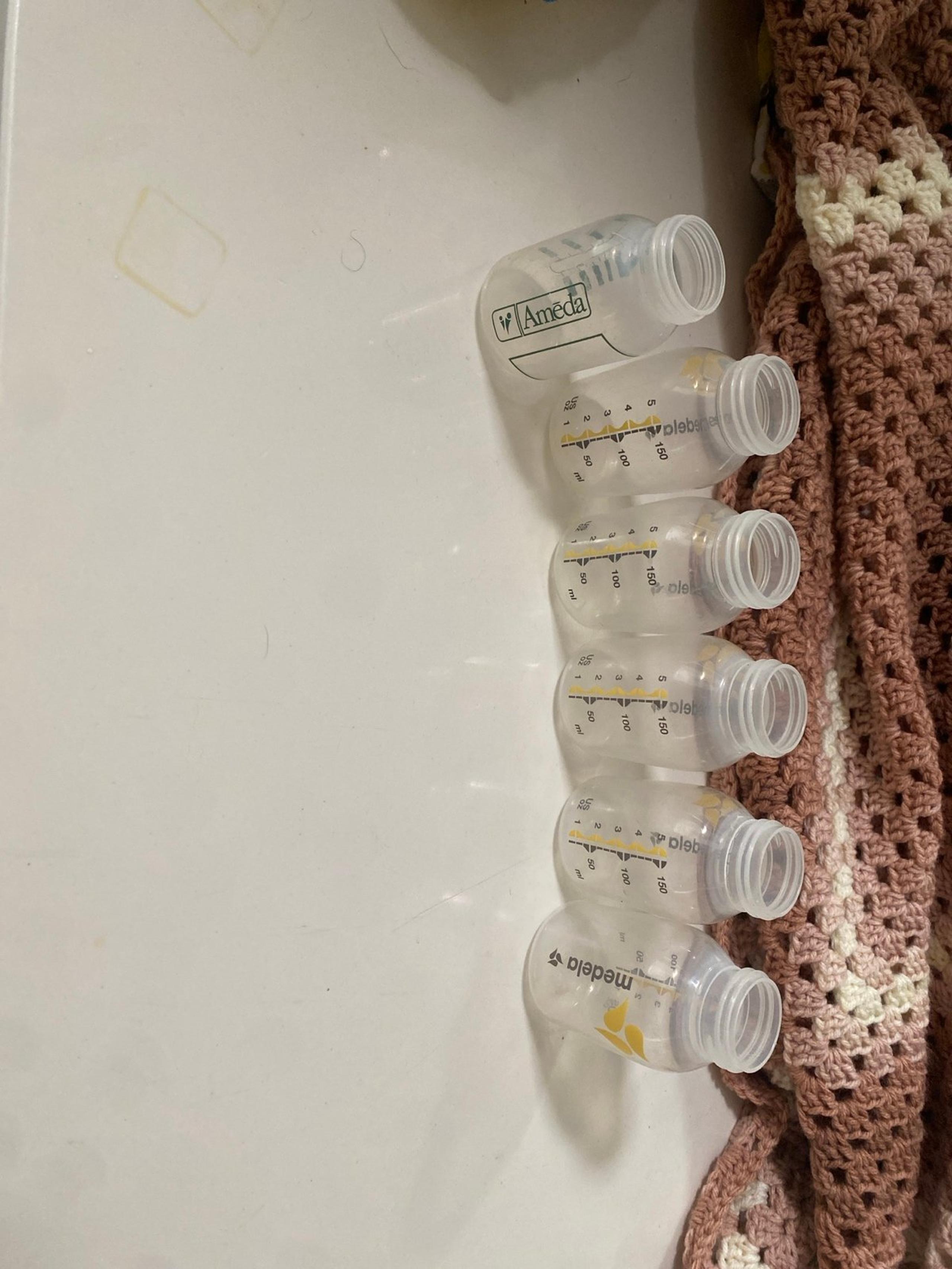5 Medela baby bottles 5oz.  1 Ameda 4oz bottle