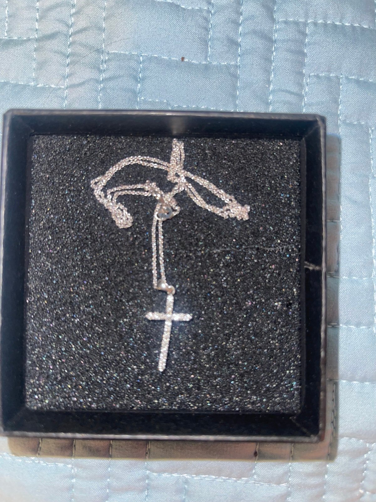 14k white gold cross with .75 carats minted diamonds on a 10k white gold chain