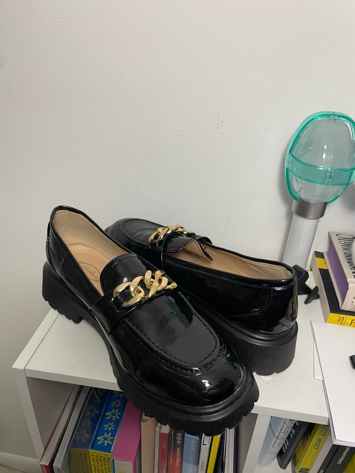 black loafers with gold chain detail