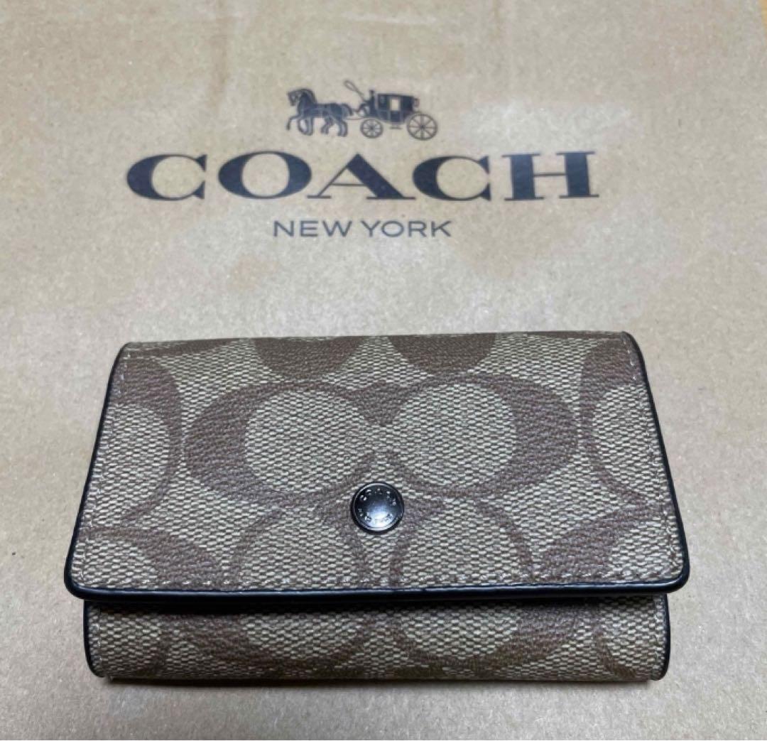 Brand new, unused COACH key case in Saddle color.