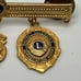 10k gold filled District Chairman Lions lapel pin with charms 1996-97