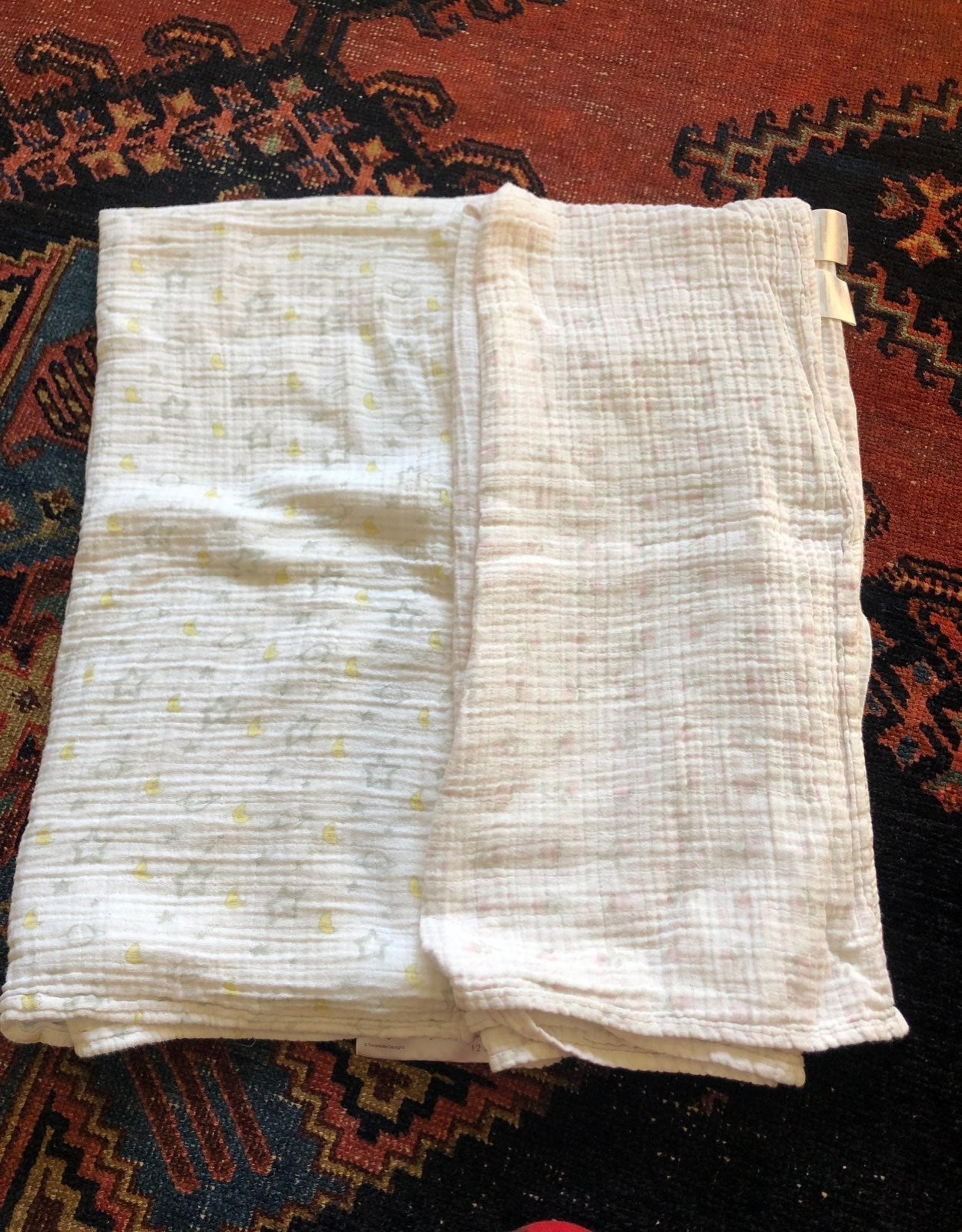 two muslin cotten swaddle blankets