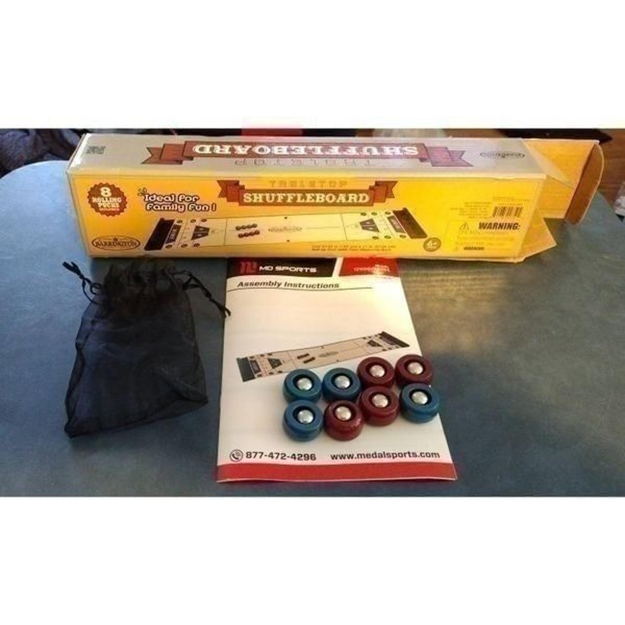 tabletop shuffleboard game is a portable version of the classic pub-style game.