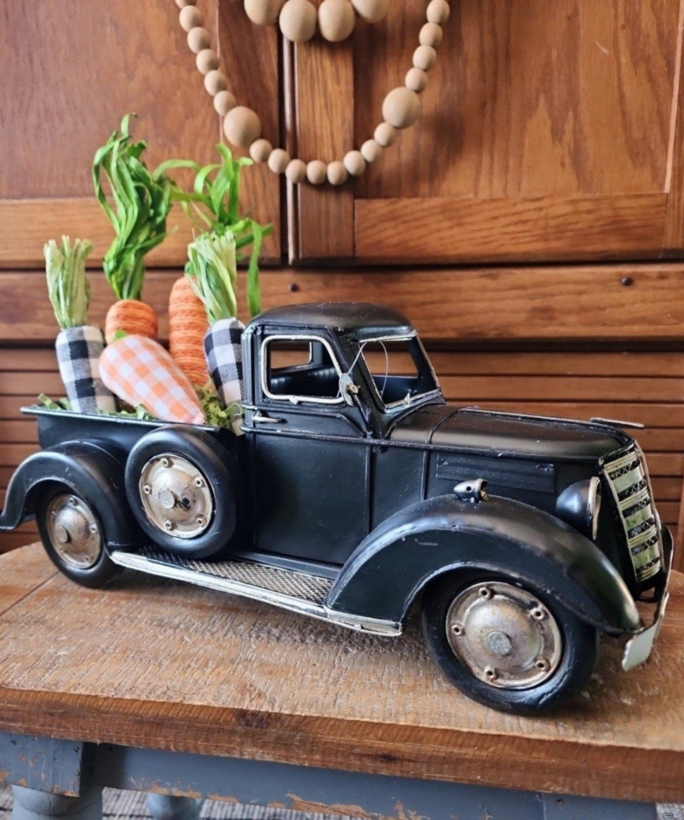 Farmhouse vintage inspired black metal pickup truck & buffalo check carrots