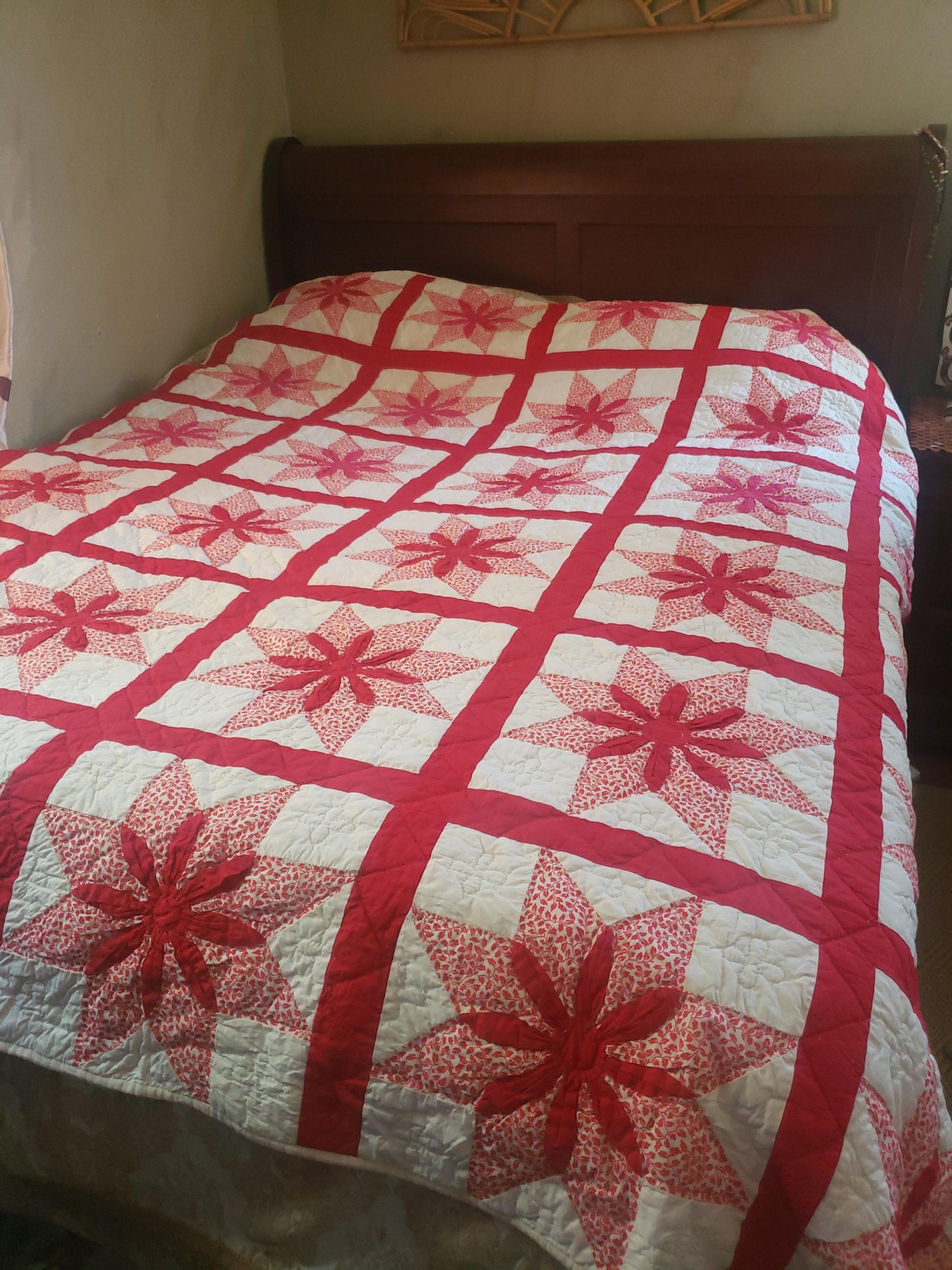 Handmade stitching in red and pink flowers quilt