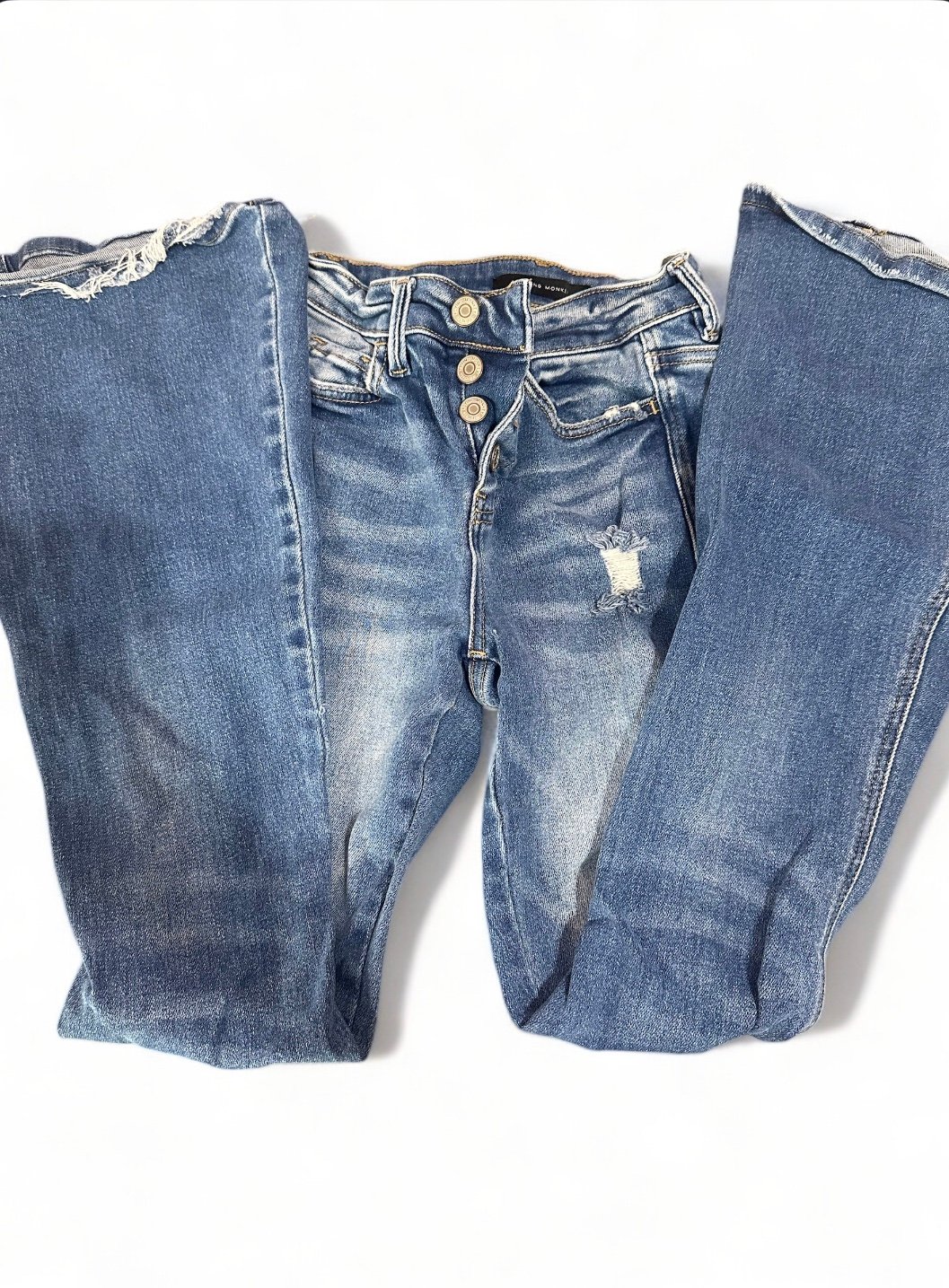 High rise flare jeans with cute button detailing and distressed details.