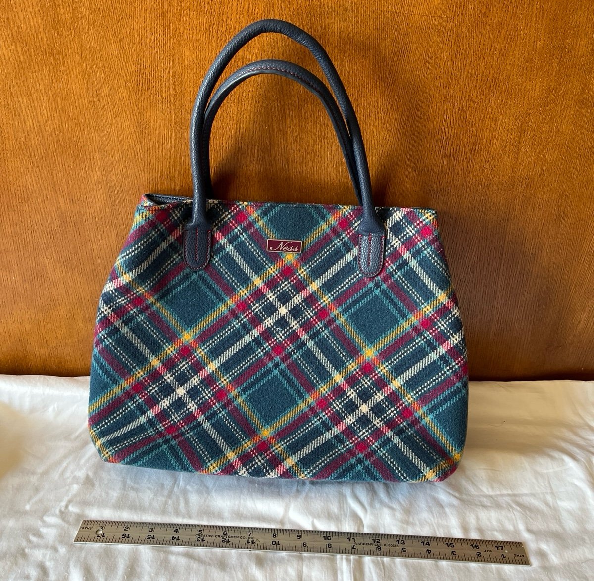 Ness teal plaid wool/polyester handbag with polyurethane handles.