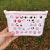 Target toy shopping baskets in red and pink in hand