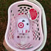 Target toy shopping baskets in red and pink in hand