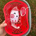 Target toy shopping baskets in red and pink in hand