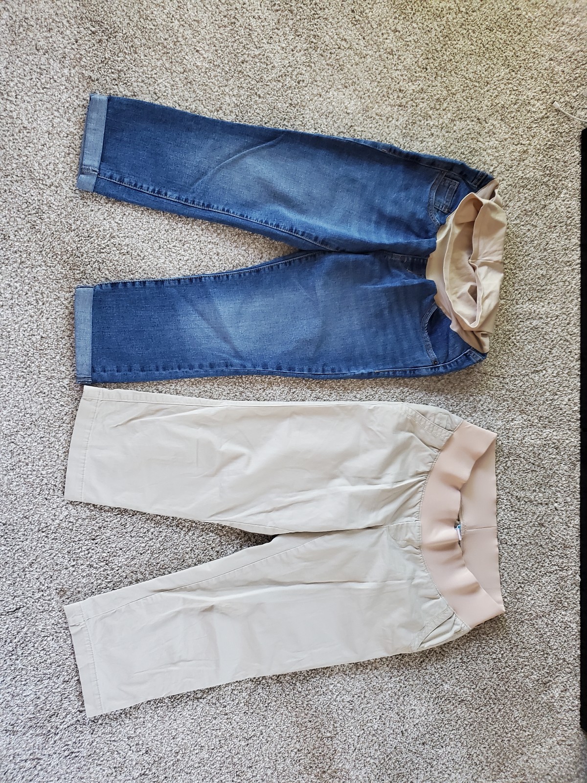 Maternity clothes including jeans, capris, sweaters, shirts, and dress pants