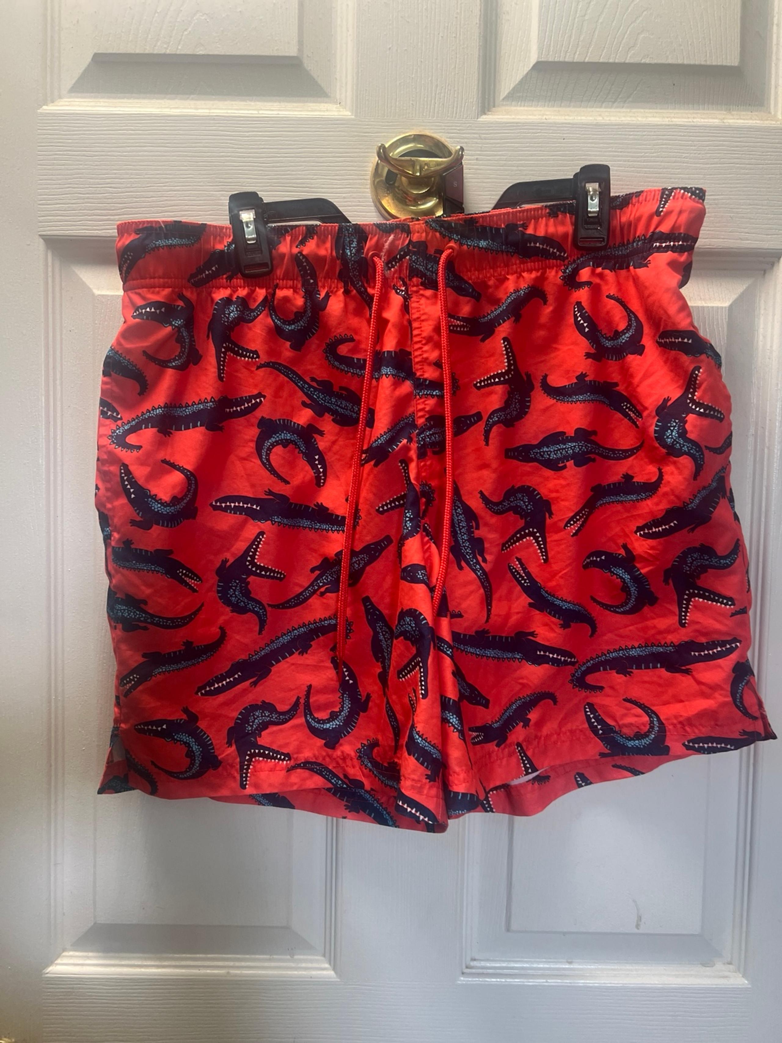 Men’s swim trunks by George size large orange with alligators on them