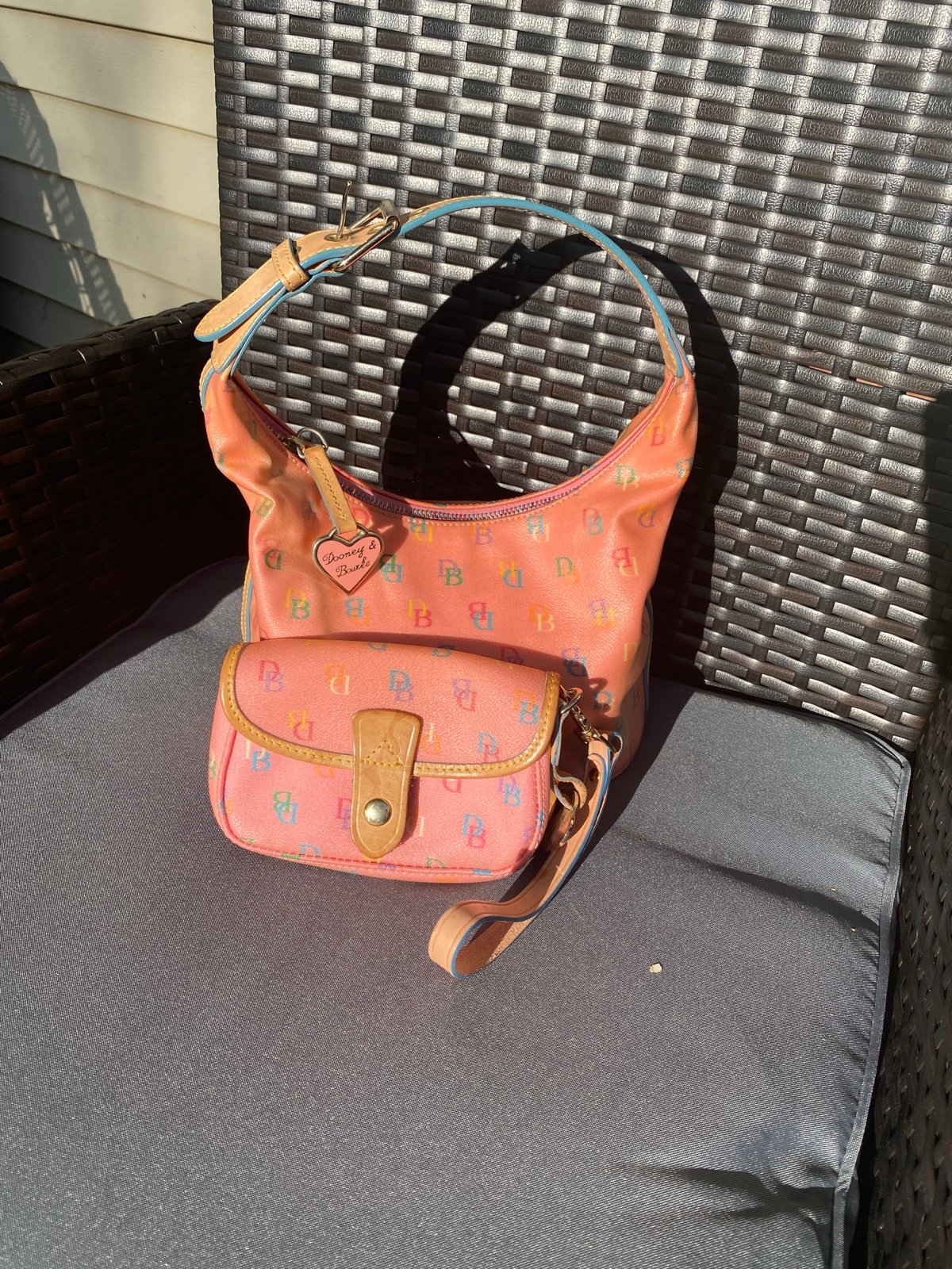 Vintage Dooney and Bourke pink monogram leather bucket bag with coin purse