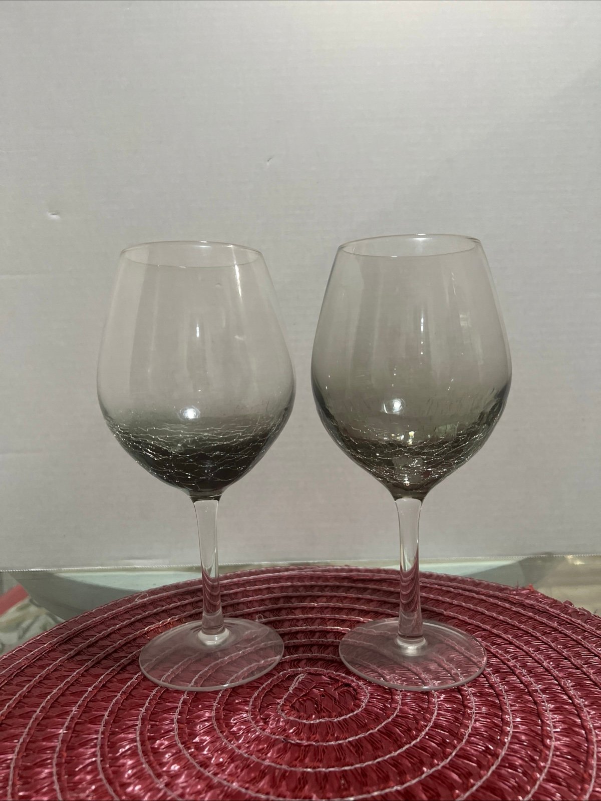 a set of 2 Pier 1 crackle smoke gray balloon wine glasses. They have a stemmed d