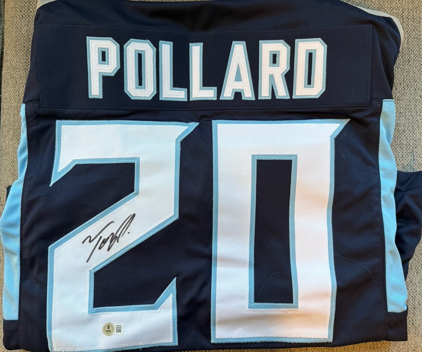 Titans bundle signed Tony Pollard jersey and Jevon Kearse ball.
