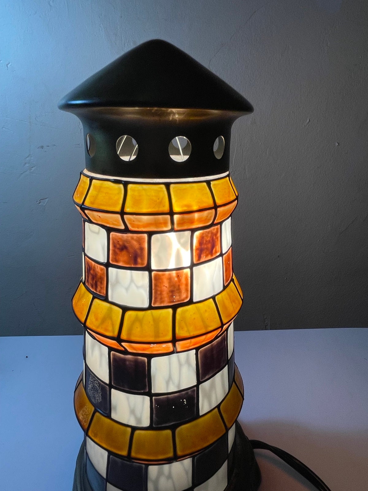 Stained glass lighthouse lamp. Measures 11 tall and 5 at base