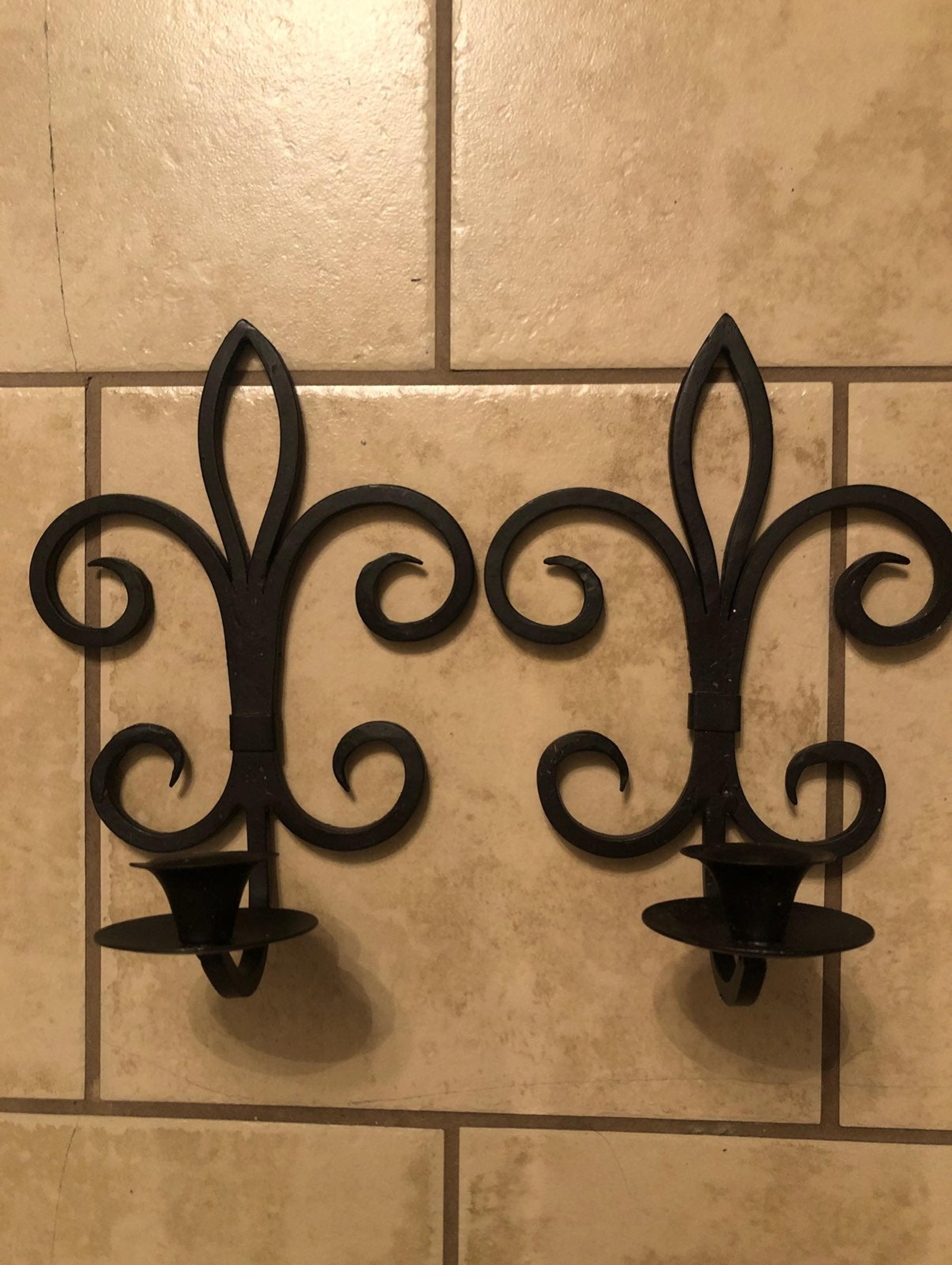 Two wrought iron candle stick holders