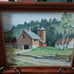 Framed painting of old barn and house.