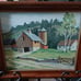 Framed painting of old barn and house.