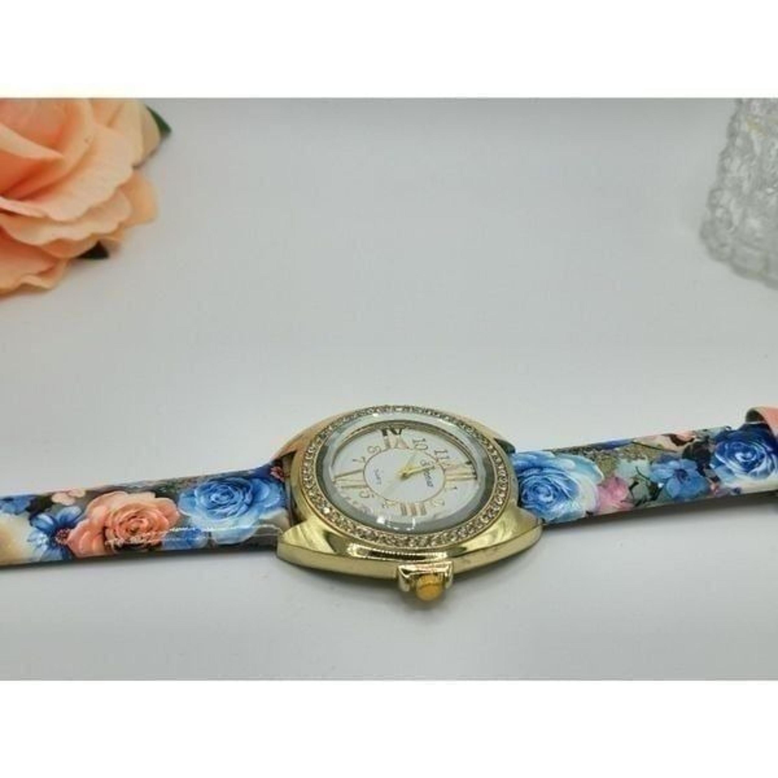 Woman's Geneva Gold rhinestone floral wristwatch