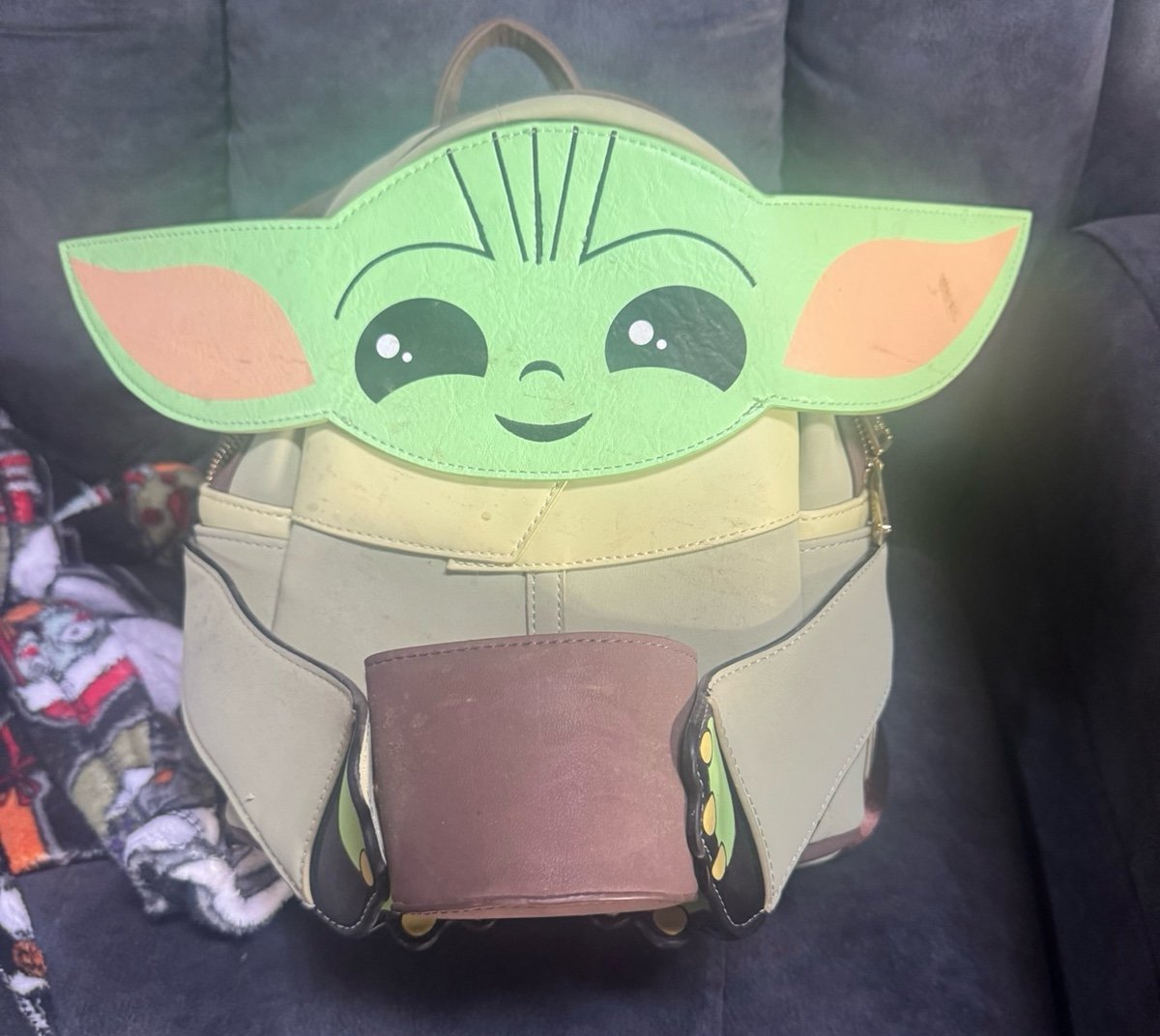 Baby Grogu from the Mandalorian loungefly holding cup