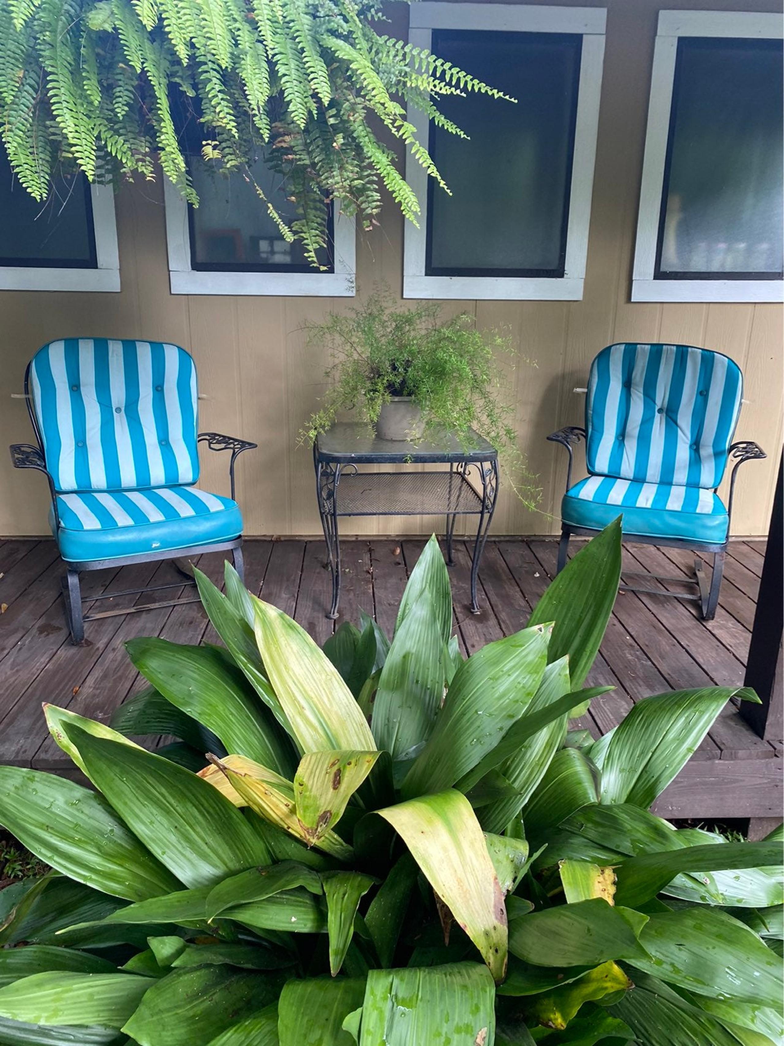 Wrought Iron Spring Back chairs with leather cushions and glass top table