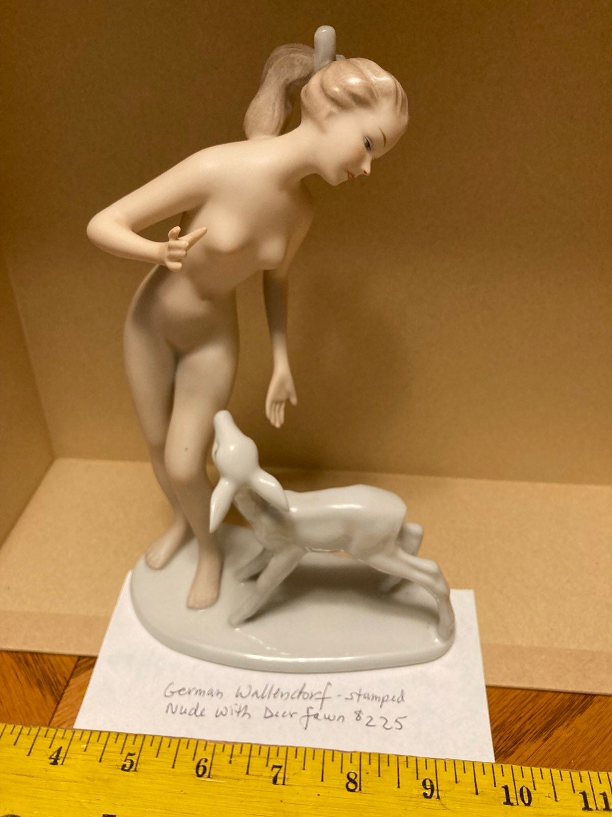 Nude with deer fawn