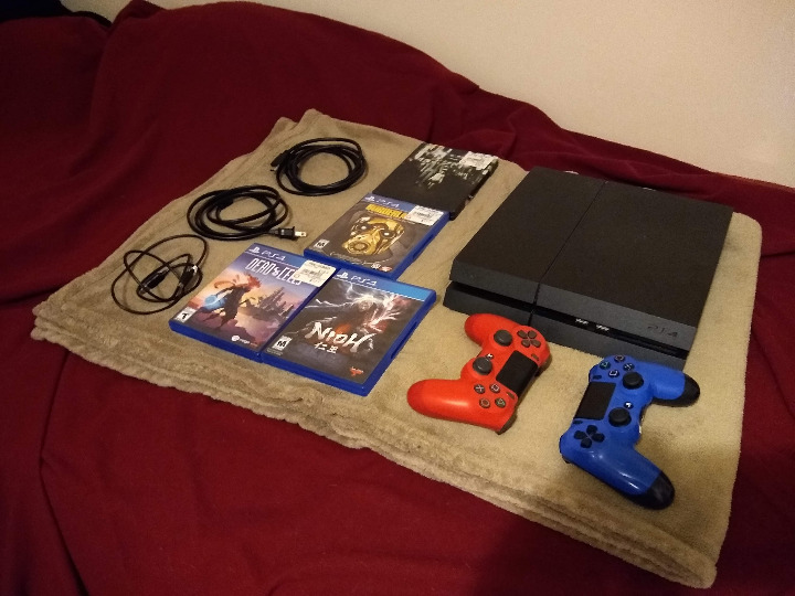 PS4 with Controllers and Games