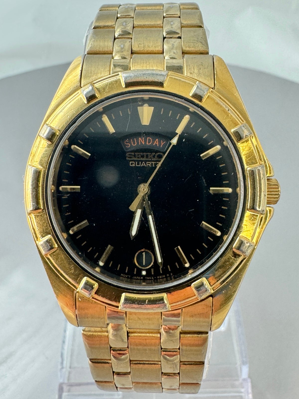 Seiko 37mm Men’s Watch with Day/Date Gold Tone Black Dial 7N43-6A79