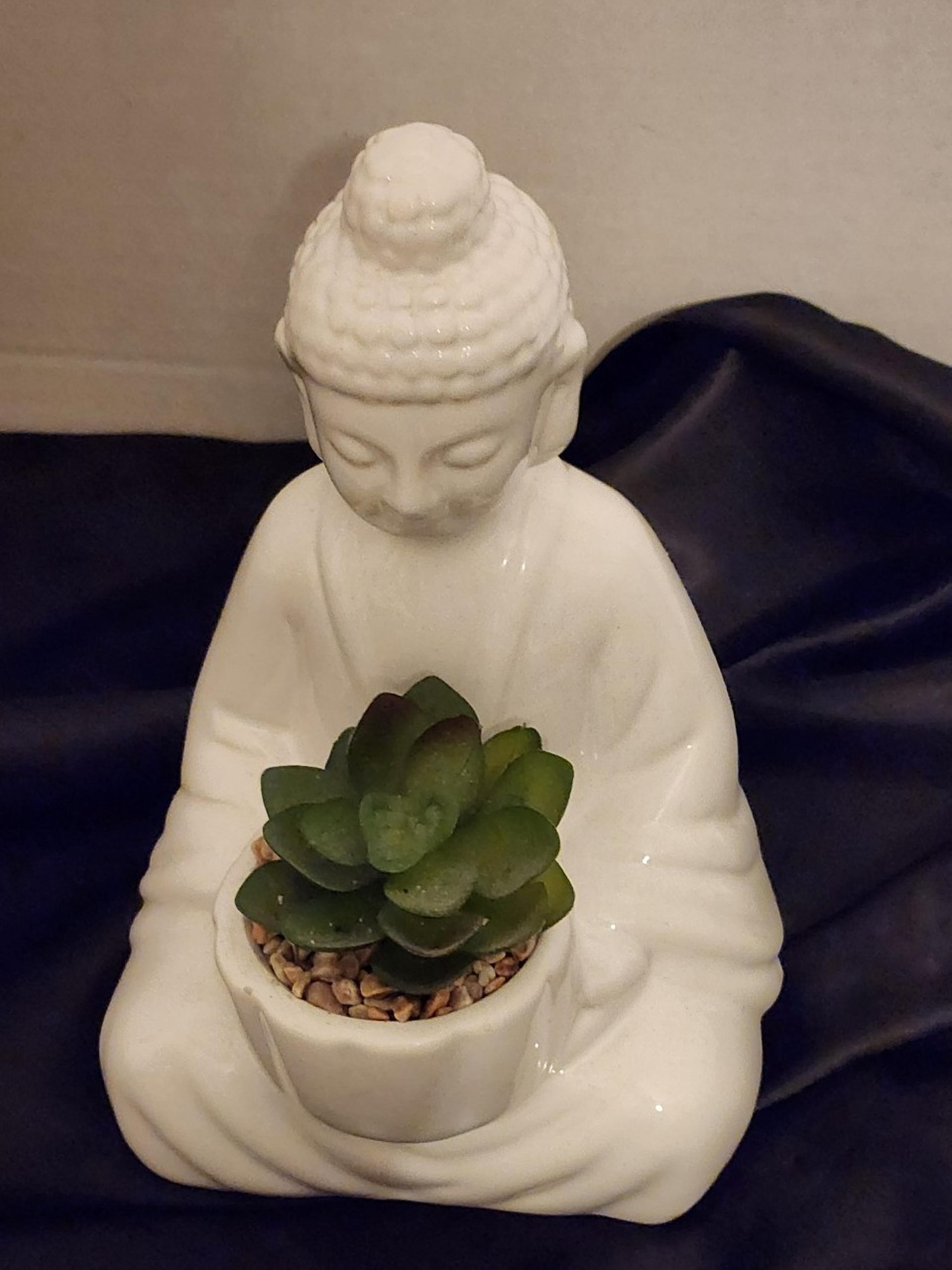 Buddha statues holding faux succulent 8 inches tall.